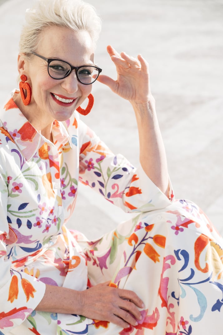 Woman in Floral Dress Wearing Black Framed Eyeglasses